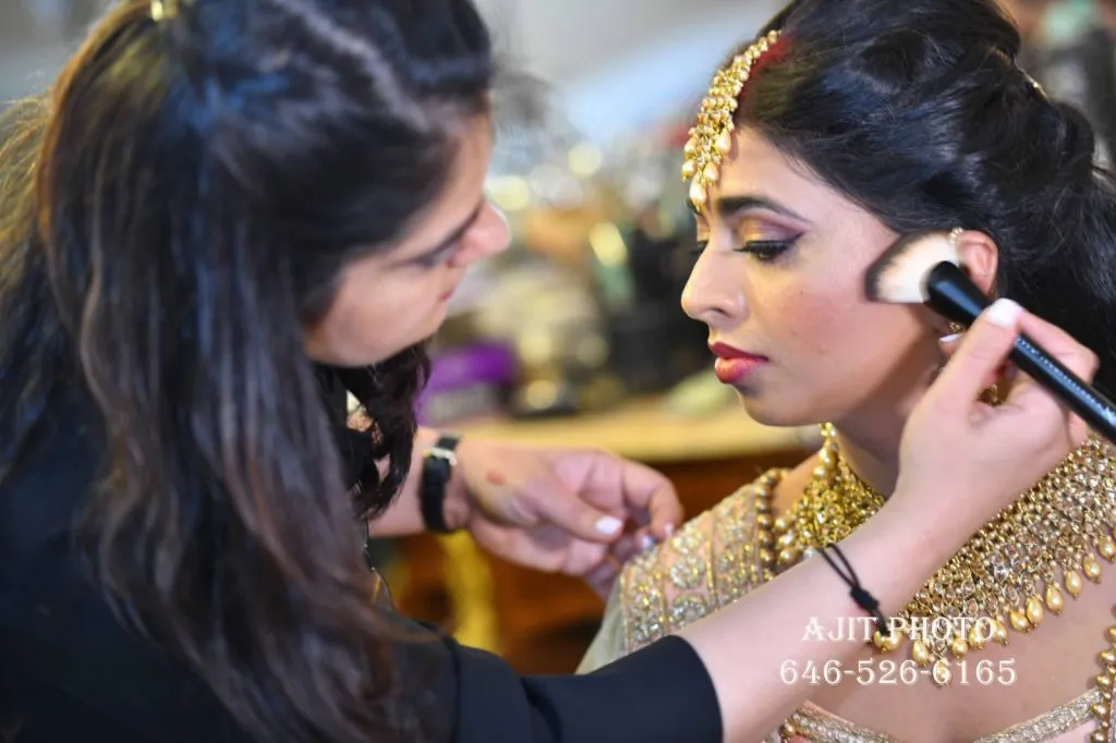 Bridal makeup artist applying makeup to bride before wedding ceremony