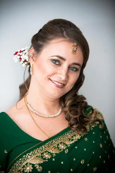 Wedding guest makeup and hairstyling with traditional jewelry