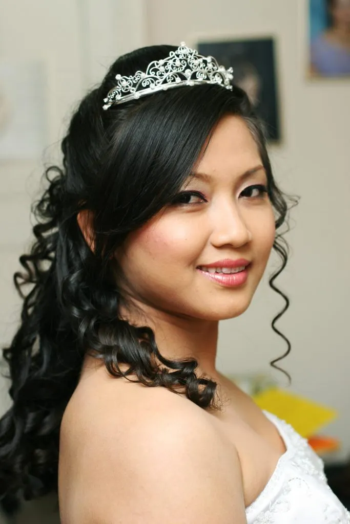 Bridal makeup and hairstyle with tiara and wedding gown