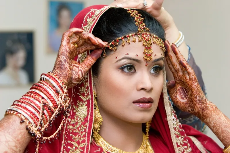 Bride with bridal henna and traditional Indian wedding jewelry