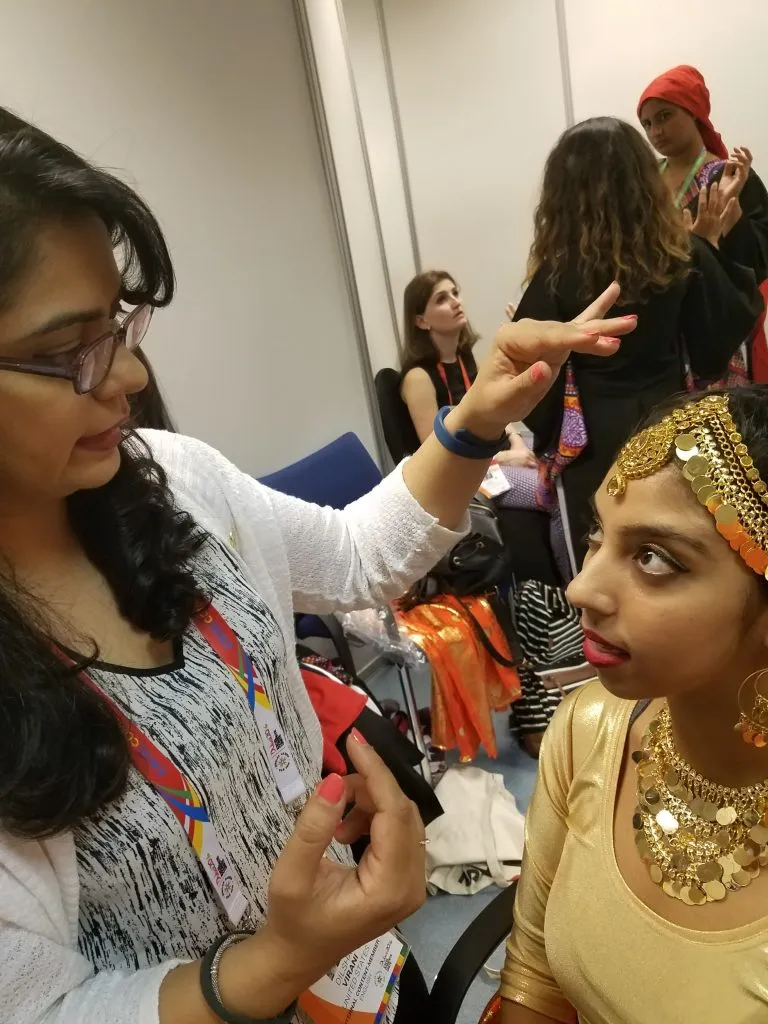 Makeup artist consulting with model during bridal makeup preparation