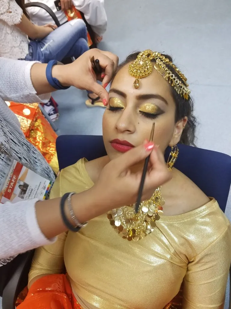 Professional makeup artist applying eye makeup for bridal photoshoot